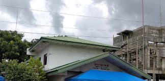 A tricycle passes by a barricaded headquarters of the Municipal Disaster Risk Reduction and Management Office in Oton, Iloilo. Six of the agency’s personnel contracted coronavirus. PANAY NEWS