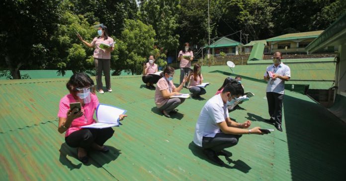 teachers Teachers at a secondary school in Batangas City climb on the roof to access a better internet connection as they monitor their students’ activities during the school year’s opening on Monday, Oct. 5, 2020. PHOTO VIA ABS-CBN NEWS