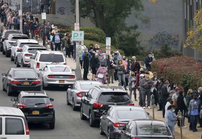 Voters line up in front of the Yonkers Public Library in Yonkers, New York, United States on Oct. 24, 2020 as the first day of early voting in the presidential election begins across the state. MARK VERGARI/THE JOURNAL NEWS VIA AP Voters line up in front of the Yonkers Public Library in Yonkers, New York, United States on Oct. 24, 2020 as the first day of early voting in the presidential election begins across the state. MARK VERGARI/THE JOURNAL NEWS VIA AP