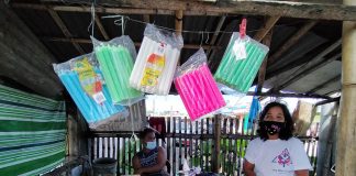 Elena Paciente sells candles outside the public cemetery of Santa Barbara, Iloilo on Oct. 28. She laments the slow crawl of sales as authorities order a weeklong shutdown of cemeteries to avoid massive gathering that could increase risk of coronavirus transmission. IAN PAUL CORDERO/PN