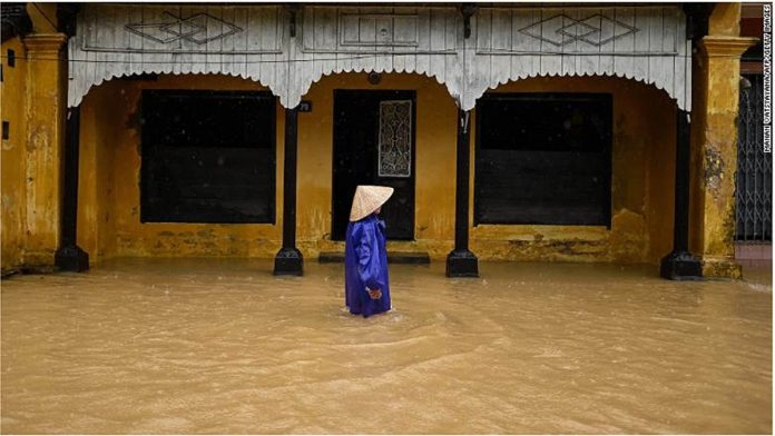 A woman wades through floodwaters along a street in central Vietnam’s city of Hue on Oct. 17, 2020. AFP PHOTO