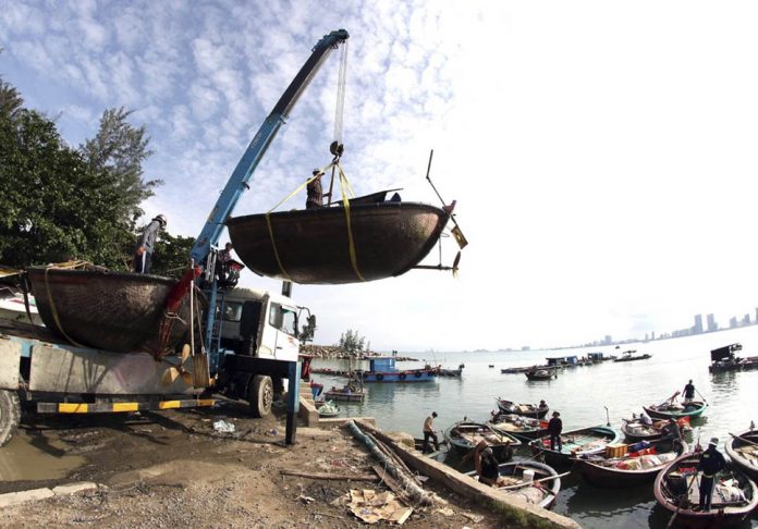 vietnam People move fishing boats to save place ahead of Typhoon Molave in Danang, Vietnam on Monday, Oct. 26, 2020. TRAN LE LAM/VNA VIA AP
