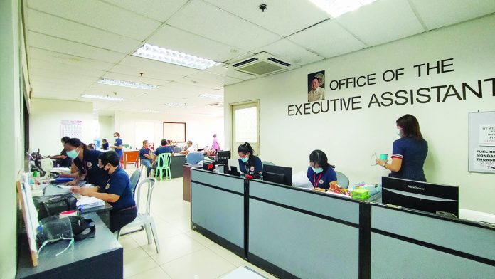 Iloilo city sets fund for vaccine Employees wear facemasks inside the Office of the Executive Assistant of the Iloilo City Hall. City government workers will have priority access to coronavirus vaccine should this become available next year, says Mayor Jerry Treñas. IAN PAUL CORDERO/PN