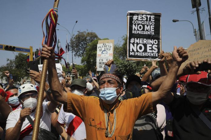 PERU Protesters celebrate the resignation of interim president Manuel Merino in Lima, Peru, Sunday, Nov. 15, 2020. Merino stepped down Sunday after two people were killed the night before during a wave of protests unleashed when Congress ousted President Martin Vizcarra. RODRIGO ABD/AP PHOTO