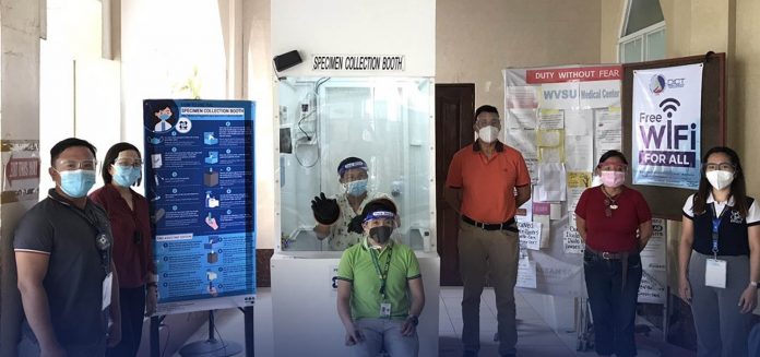 SCB-Iloilo The West Visayas State University Medical Center (WVSUMC) in Jaro, Iloilo City receives from DOST VI representatives the contactless Specimen Collection Booth to aid the prevention and control of the spread of COVID-19 in the region. Present in the turn over activity are WVSUMC Chief Dr. Dave Endel R. Gelito III (3rd from right), medical technologists of WVSUMC and DOST VI staff Mr. Joeben V. Gubatanga (far left) and Mia C. Pielago (far right).