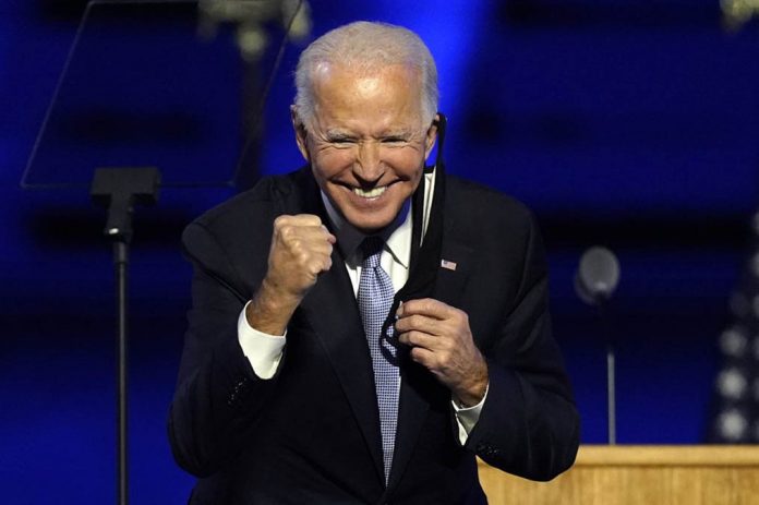 President-elect Joe Biden gestures to supporters Saturday, Nov. 7, 2020, in Wilmington, Delaware, United States. ANDREW HARNIK/AP PHOTO