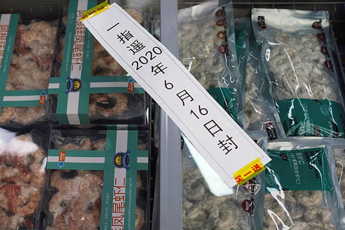 Frozen seafood products made of imported shrimps are seen inside a sealed freezer at a supermarket following a new outbreak of the coronavirus in Beijing, China. CARLOS GARCIA RAWLINS/REUTERS Frozen seafood products made of imported shrimps are seen inside a sealed freezer at a supermarket following a new outbreak of the coronavirus in Beijing, China. CARLOS GARCIA RAWLINS/REUTERS