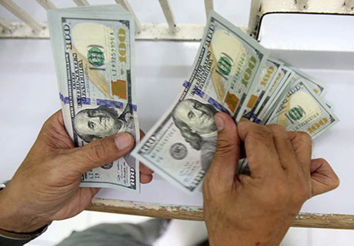 dollar A man counts dollar remittances at a money changer in United Nations Avenue in Manila. PHOTO BY RUSSELL PALMA