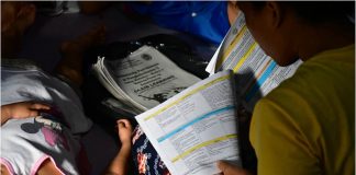 A mother assists her children in their online classes as public schools opened amid the COVID-19 pandemic on Oct. 5, 2020. MARK DEMAYO/ABS-CBN NEWS