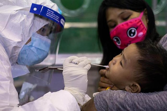nation A child gets a coronavirus disease swab testing at a gymnasium in Navotas City, Metro Manila on Aug. 7, 2020. ELOISA LOPEZ/REUTERS