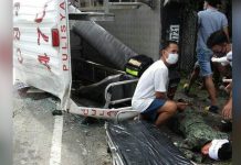 Rescuers help an injured policeman (right) after this police patrol car of Culasi, Antique fell on its side in Barangay Bongsod, Sibalom, Antique.