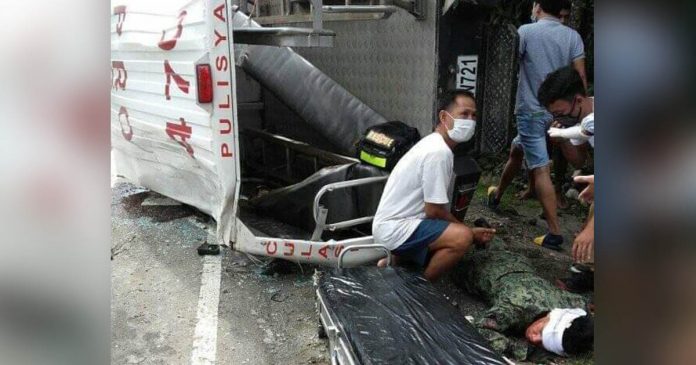 Rescuers help an injured policeman (right) after this police patrol car of Culasi, Antique fell on its side in Barangay Bongsod, Sibalom, Antique.