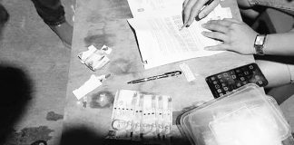 A police operative conducts an inventory of the items seized from drug suspect Alexis Barial Diangson in Kalibo, Aklan. PHOTO BY RODNEL AGUIRRE, RMN KALIBO