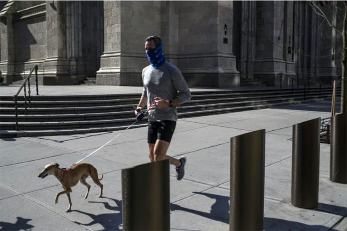 A masked runner and his dog pass St. Patrick’s Cathedral in midtown Manhattan on April 12, 2020. Many of us have been moving less since the pandemic began, but some, including many older men and women, seem to be moving more. VICTOR J. BLUE/THE NEW YORK TIMES A masked runner and his dog pass St. Patrick’s Cathedral in midtown Manhattan on April 12, 2020. Many of us have been moving less since the pandemic began, but some, including many older men and women, seem to be moving more. VICTOR J. BLUE/THE NEW YORK TIMES