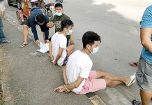 Jaro antidrug sting nets 2 The 24-year-old Juno Samontanes and 19-year-old-old AJ Mar Pari-an sit handcuffed while antidrug operatives inspect sachets of suspected shabu during a buy-bust operation in Barangay Tagbak, Jaro, Iloilo City on Dec. 13. IAN PAUL CORDERO/PN