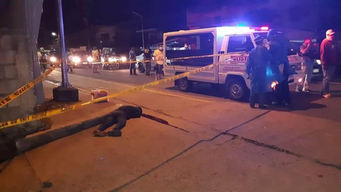Jeepney dispatcher Mitzel Yap lies dead on the road. Two motorcycle-riding unidentified gunmen shot Yap in Barangay Alijis, Bacolod City on Dec. 16. DYEZ AKSYON RADYO BACOLOD