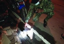 Boutique owner shot to death outside store A police officer points to a spent bullets of a .45-caliber gun recovered after a shooting incident on Rizal Street, Barangay 9, Kabankalan City, Negros Occidental on Dec. 11. CONTRIBUTED PHOTO