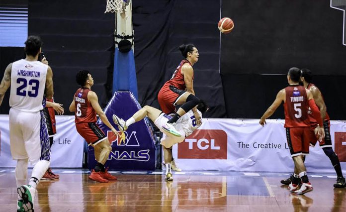 Barangay Ginebra San Miguel Kings’ Japeth Aguilar runs over TNT Tropang Giga’s Roger Pogoy as he chase for a loose ball in Game 2 of their 2020 PBA Philippine Cup finals on Wednesday night. PBA PHOTO Barangay Ginebra San Miguel Kings’ Japeth Aguilar runs over TNT Tropang Giga’s Roger Pogoy as he chase for a loose ball in Game 2 of their 2020 PBA Philippine Cup finals on Wednesday night. PBA PHOTO
