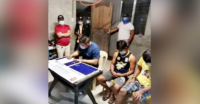 buy bust banago Drugs suspects Jerby Serquillos, 32, and Allen Carepiano, 25, sit handcuffed while authorities conduct an inventory of the suspected shabu seized in a buy-bust operation in Barangay Banago, Bacolod City on Dec. 10. BCPO