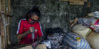 This firecracker worker is busy finishing a batch of skyrockets in a makeshift factory. Setting off firecrackers during the holiday season, especially when welcoming the New Year, is an age-old Filipino tradition. IAN PAUL CORDERO/PN