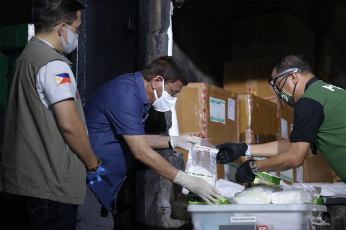 President Rodrigo Duterte inspects seized illegal drugs at a facility in Trece Martires City, Cavite on Thursday. Some P7.5 billion worth of illegal narcotics were destroyed in the event. KARL NORMAN ALONZO/PRESIDENTIAL PHOTO