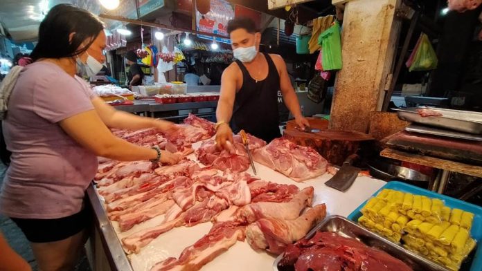 SAFE MEAT. A meat vendor at the public market of La Paz, Iloilo City tends to his customer. The Department of Agriculture advised the public to buy pork products that are inspected and certified by the National Meat Inspection Service. IAN PAUL CORDERO/PN SAFE MEAT. A meat vendor at the public market of La Paz, Iloilo City tends to his customer. The Department of Agriculture advised the public to buy pork products that are inspected and certified by the National Meat Inspection Service. IAN PAUL CORDERO/PN