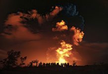 People watch an eruption from Hawaii’s Kilauea volcano in the Big Island on Dec. 20, 2020. JANICE WEI/NATIONAL PARK SERVICE VIA AP