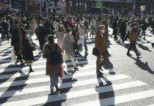 Japan bans entry of foreign nationals Passersby wearing protective face masks walk on the Shibuya crossing amid the COVID-19 outbreak in Tokyo, Japan on Dec. 26, 2020. KYODO/REUTERS
