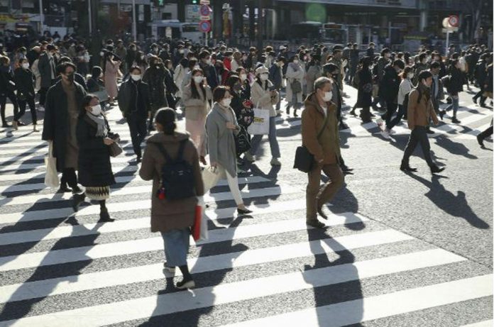 Passersby wearing protective face masks walk on the Shibuya crossing amid the COVID-19 outbreak in Tokyo, Japan on Dec. 26, 2020. KYODO/REUTERS Passersby wearing protective face masks walk on the Shibuya crossing amid the COVID-19 outbreak in Tokyo, Japan on Dec. 26, 2020. KYODO/REUTERS