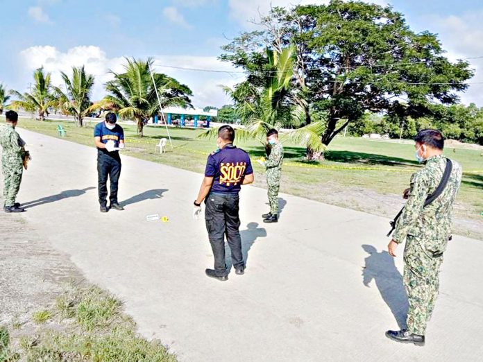 Scene of the crime operatives investigate the reclamation area of Pontevedra, Negros Occidental where Police Staff Sergeant Ildefonso Casugod was shot dead by an unidentified motorcycle-riding gunman on Tuesday. PONTEVEDRA MUNICIPAL POLICE STATION