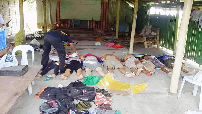 region Antique 7 REBELS OR NOT? A policeman checks the bodies of suspected New People’s Army rebels killed in a predawn gunfight in Barangay Atabay, San Jose, Antique on Aug. 15, 2018. PN FILE PHOTO