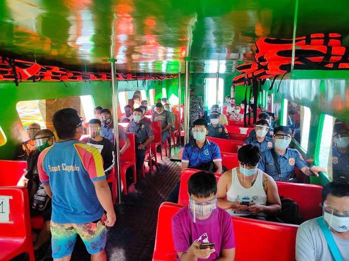 Inside this Boracay Island-bound boat, passengers wear facemasks and face shields to prevent the spread of coronavirus disease 2019. PHILIPPINE COAST GUARD-AKLAN PHOTO