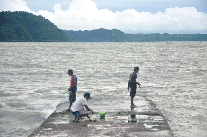 This portion of the breakwater of Fort San Pedro in Iloilo City is the perfect spot for fishing, according to these men. From a distance could be seen the island province of Guimaras. PN PHOTO This portion of the breakwater of Fort San Pedro in Iloilo City is the perfect spot for fishing, according to these men. From a distance could be seen the island province of Guimaras. PN PHOTO