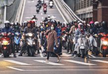 A pedestrian crosses the street during rush hour in Taipei, Taiwan. AN RONG XU/THE NEW YORK TIMES