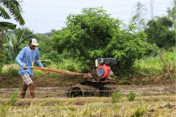 Using a hand tractor, a farmer prepares his land in Imus, Cavite. An agricultural group has urged the government to vaccinate around 11 million farmers against COVID-19 using funds from its collection of deboned meat tariff. PHOTO COURTESY OF PNA
