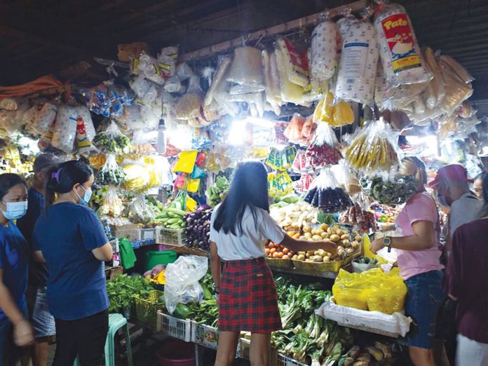 People shop various food items at a stall inside the public market of Leganes, Iloilo on Jan. 10, 2021. The Department of Trade and Industry said it is running after vendors who violate suggested retail prices for food products. Panay News photo Photo for representation only. People shop various food items at a stall inside the public market of Leganes, Iloilo on Jan. 10, 2021. Panay News photo