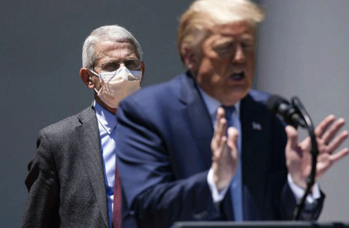 Dr. Anthony Fauci, the nation’s leading infectious disease specialist, looks on as President Donald Trump speaks to reporters at the White House on May 15, 2020. SAMUEL CORUM/THE NEW YORK TIMES Dr. Anthony Fauci, the nation’s leading infectious disease specialist, looks on as President Donald Trump speaks to reporters at the White House on May 15, 2020. SAMUEL CORUM/THE NEW YORK TIMES