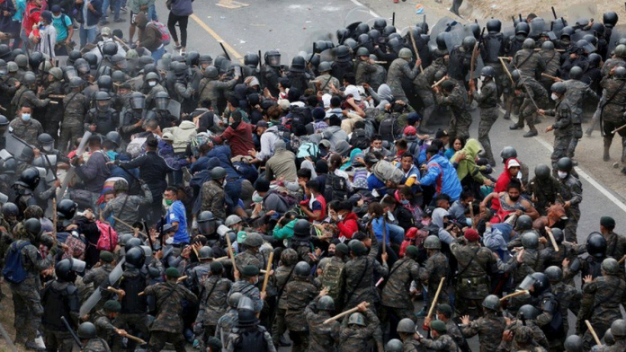 Police and troops used sticks to beat them back. REUTERS Police and troops used sticks to beat them back. REUTERS