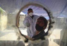 India OKs AstraZeneca, locally-made vaccines A health worker takes a nasal swab sample at a COVID-19 testing center in Hyderabad, India on Jan. 2, 2021. MAHESH KUMAR A./AP PHOTO