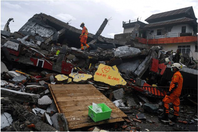 Search and rescue personnel inspect a collapsed building following an earthquake in Mamuju, West Sulawesi province in Indonesia on Jan. 16, 2021. ANTARA FOTO/SIGID KURNIAWAN VIA REUTERS