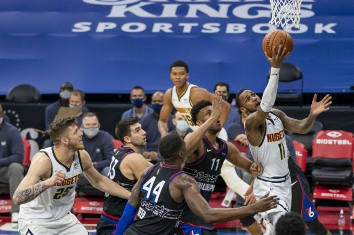 Denver Nuggets’ Monte Morris goes up for the shot against Philadelphia 76ers’ Tony Bradley and Paul Reed during the first half of their NBA basketball game on Jan. 9, 2021. CHRIS SZAGOLA/AP PHOTO