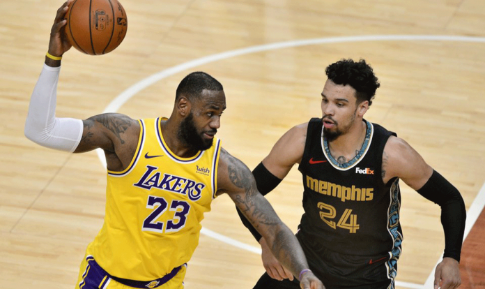 Los Angeles Lakers forward LeBron James handles the ball against Memphis Grizzlies guard Dillon Brooks in the second half of an NBA basketball game on Jan. 5, 2021 in Memphis, Tennessee, United States. BRANDON DILL/AP PHOTO Los Angeles Lakers forward LeBron James handles the ball against Memphis Grizzlies guard Dillon Brooks in the second half of an NBA basketball game on Jan. 5, 2021 in Memphis, Tennessee, United States. BRANDON DILL/AP PHOTO