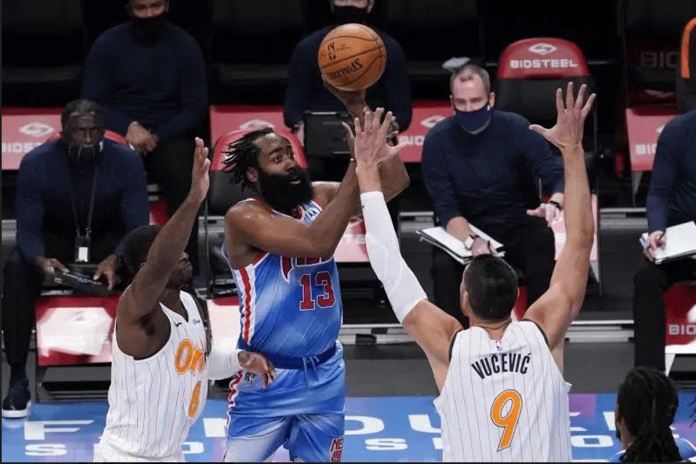 Brooklyn Nets guard James Harden is defended by two Orlando Magic players. PHOTO BY MARY ALTAFFER/AP Brooklyn Nets guard James Harden is defended by two Orlando Magic players. PHOTO BY MARY ALTAFFER/AP