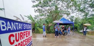 Personnel of the Passi City government man a curfew checkpoint on Friday. Due to surge of coronavirus infections, Passi reverted to enhanced community quarantine for two weeks. CURFEW CHECKPOINT