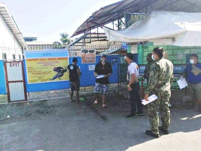 region-Kalibo-cockpit-arena Personnel of the municipal government and police station of Kalibo, Aklan serve a notice of temporary closure to a cockpit in Kalibo, Aklan for disinfection. PHOTO PNP KALIBO