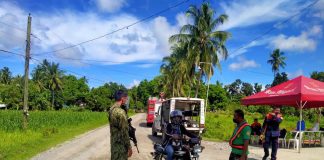 Policemen of Numancia, Aklan flags down a motorist in Sitio Ilaya, Barangay Aliputos. The sitio is on lockdown due to coronavirus disease. PHOTO NUMANCIA AKLAN PNP