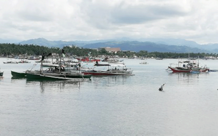 region-antique-missing-fishermen ANCHORED. Fishing boats anchor at the San Jose de Buenavista port in Antique. They are unable to venture out to the sea due to big waves caused by the northeast monsoon. PNA PHOTO BY ANNABEL CONSUELO J. PETINGLAY
