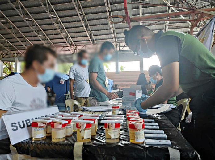 region-ime-guimaras-PDEA Guimaras drug surrenderers submit urine samples for testing at the auditorium of Nueva Valencia, Guimaras. PDEA PHOTO