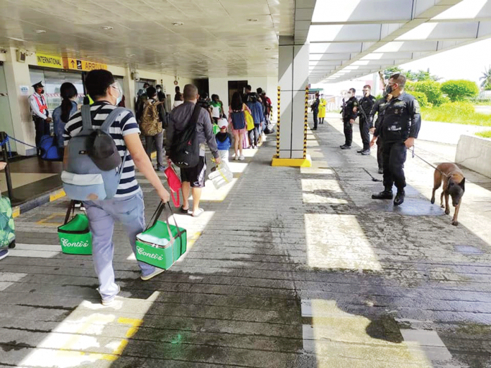 People observe physical distancing while queuing at the Kalibo International Airport to prevent the spread of coronavirus. The airport would be disinfected beginning tomorrow, Jan. 19. PHOTO by KALIBO AIRPORT PNP