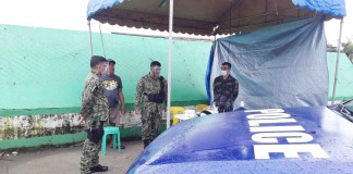Policemen set up this makeshift tent at the entrance of a purok in Kalibo, Aklan that is under a surgical lockdown due to a surge in cases of coronavirus disease. PHOTO BY KALIBO PNP